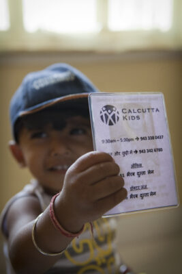 Child with Calcutta Kids contact card